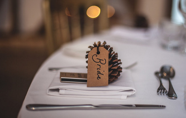 A pinecone table place setting on a wedding table