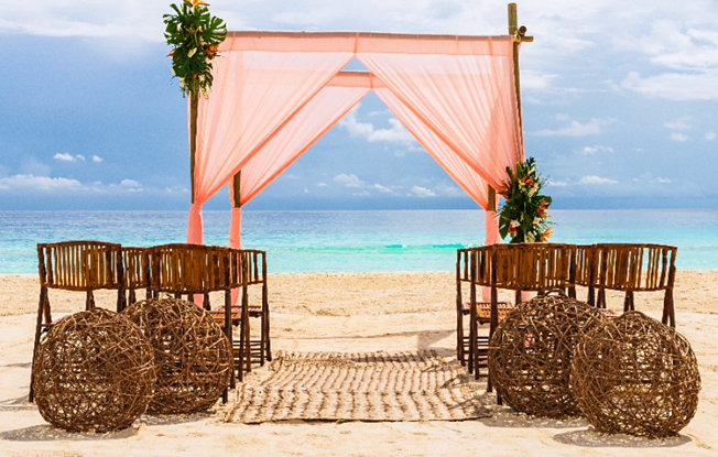 A beachfront wedding ceremony setup in Mexico
