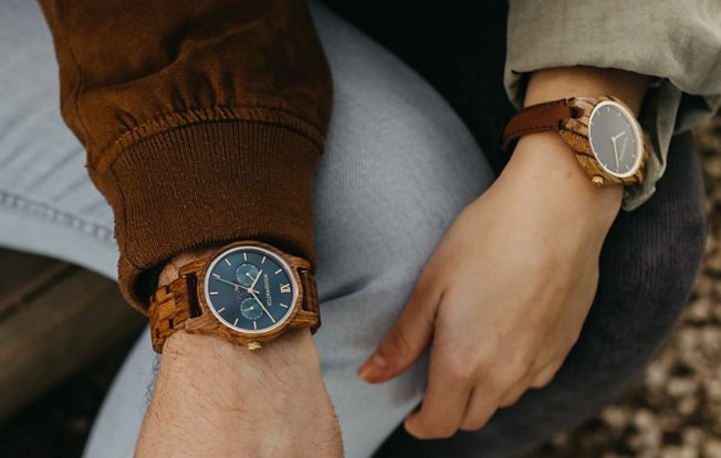 Man and Woman's wrists wearing wooden watches from WoodWatch